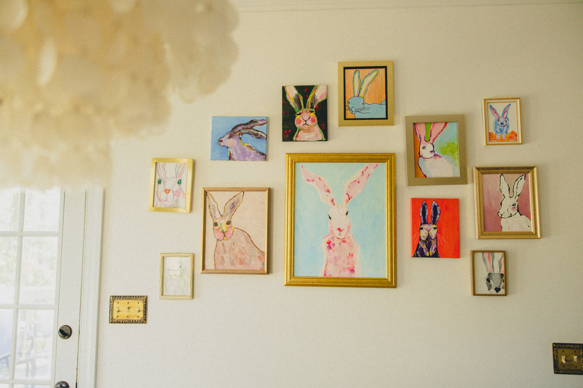 A wall of framed rabbit prints