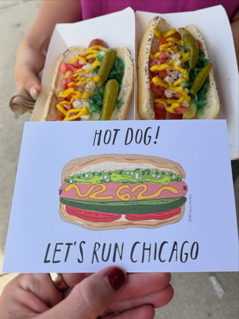 The Hot Dog! Let's Run Chicago mini print held up beside two Chicago style hot dogs