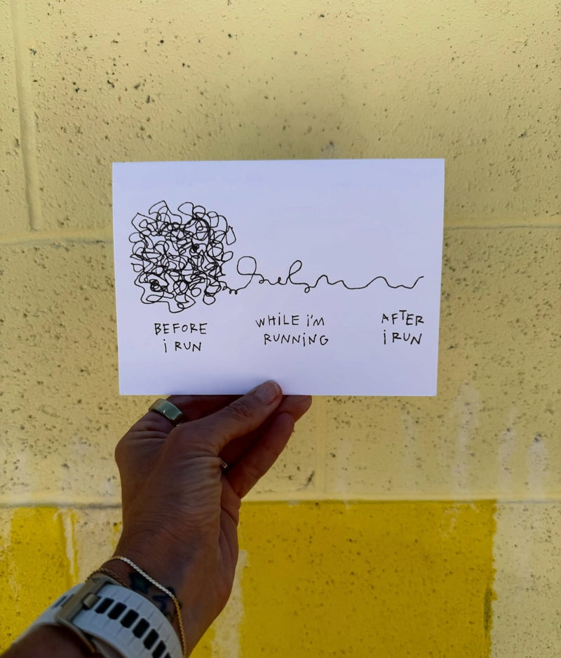 A running greeting card held against a yellow wall, a tangle of scribble before a run and a straight line after